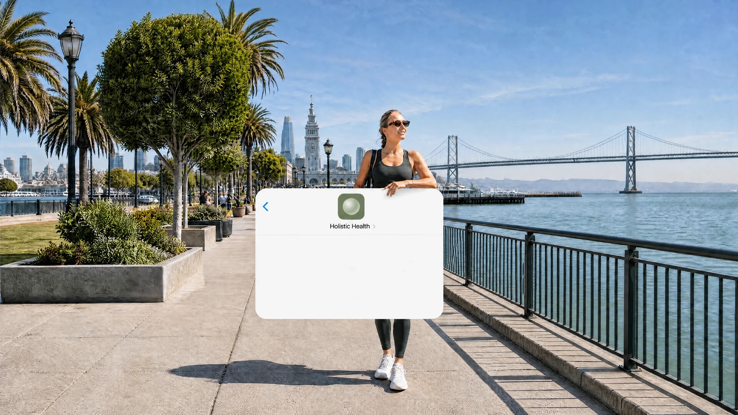 A woman on the Embarcadero pier leaning on a giant Holistic Health iMessage conversation